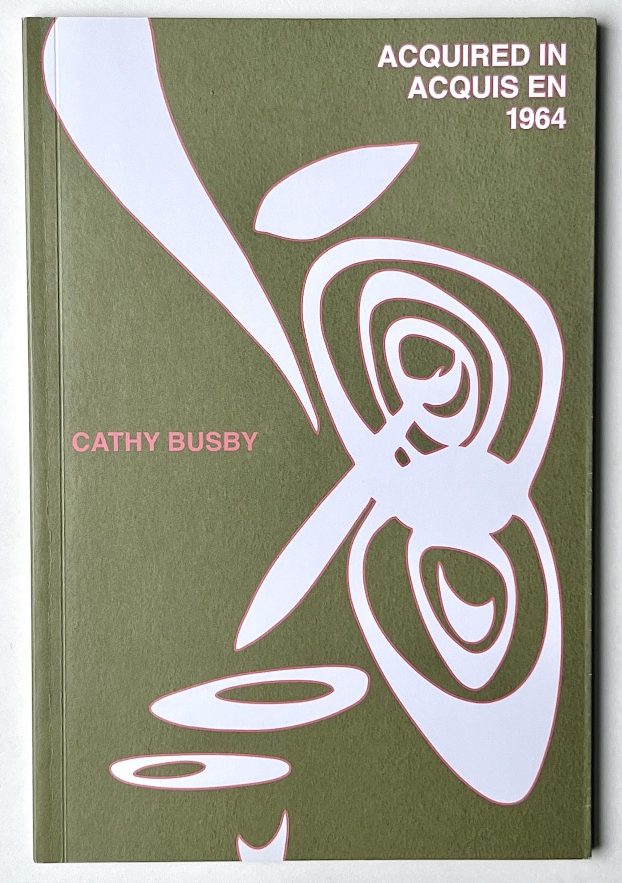 Sinuous white shapes rimmed with pink dance across the cover of a mossy green paper back book. Acquired in/Acquis en 1964 is written in the top right corner in matching pink rimmed font. Cathy Busby is written in pink in the middle of the cover.