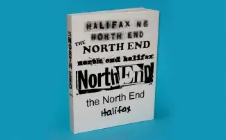 The North End Vol II stands upright against a light blue background. The white book is thick and has a cut out collage-like feel in its design. The cover reads in black lettering of varying fonts and sizes: HALIFAX NS NORTH END, THE NORTH END, NORTH END HALIFAX, NORTH END, the North End Halifax