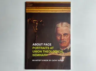 The cover of the book is a cropped picture of a damaged portrait painting in a gilded frame. An older white man with round glasses and scholar's robes directly at you, a large tear in the canvas rips down towards his face. Below his face reads: About Face: Portraits at Union Theological Seminary. An Artist's Book by Cathy Busby. 