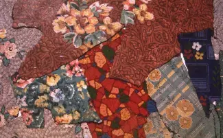 Overlapping fragments of linoleum flooring create a college as 1960s and 70s floral and textile looking patterns in burnt oranges, muddy blues, and rusty reds rub up against and tone with one another. 