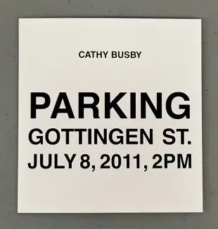 A white square of cardstock rests on a grey background. From the top down in all-caps black sans serif font is written: Cathy Busby, Parking, Gottingen St., July 8 2011, 2pm.