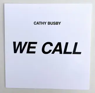 A white square of cardstock is mostly filled with the words WE CALL written in bold black sans serif font. Cathy Busby is written in smaller capitals, also in black, above the title. 