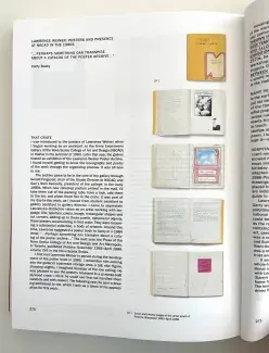  The open book spread of Cathy Busby's essay "Lawrence Weiner: Posters and Presence at NSCAD in the 1980s”  which holds a quote at the top from Weiner: “...perhaps something can transpire about a catalog of the poster archive…” and five images of Wiener’s poster book mock up.