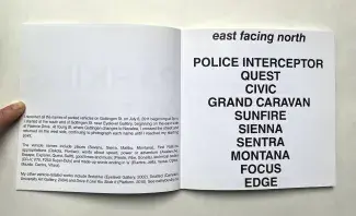 A finger holds open the white page of a square publication. The left page has a few sentences of small black text and the right holds a list in a bold black sans serif font which reads: east facing north, POLICE INTERCEPTOR, QUEST, CIVIC, GRAND CARAVAN, SUNFIRE, SIENNA, SENTRA, MONTANA, FOCUS, EDGE