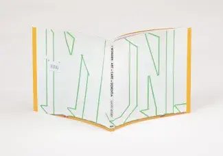 A book is splayed on a white background. The spine reads: I WONDER: ART + CARE + DEMENTIA CATHY BUSBY AM. The cover of the book is white with abstract letter-looking outlines in green painters tape. 